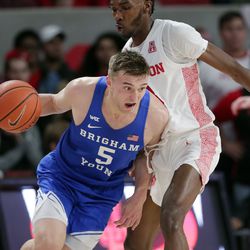 BYU guard Jake Toolson (5) drives around Houston guard DeJon Jarreau during the first half of an NCAA college basketball game Friday, Nov. 15, 2019, in Houston. 