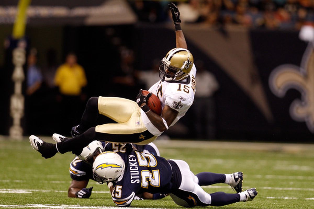 NEW ORLEANS:  Courtney Roby #15 of the New Orleans Saints is tackled by Darrell Stuckey #25 of the San Diego Chargers at the Louisiana Superdome in New Orleans Louisiana.  (Photo by Chris Graythen/Getty Images)