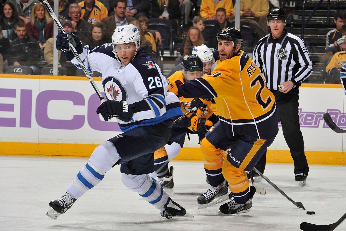 Blake Wheeler #26 of the Winnipeg Jets skates against Eric Nystrom #24 of the Nashville Predators at Bridgestone Arena on March 1, 2014 in Nashville, Tennessee. (Photo by Frederick Breedon/Getty Images)