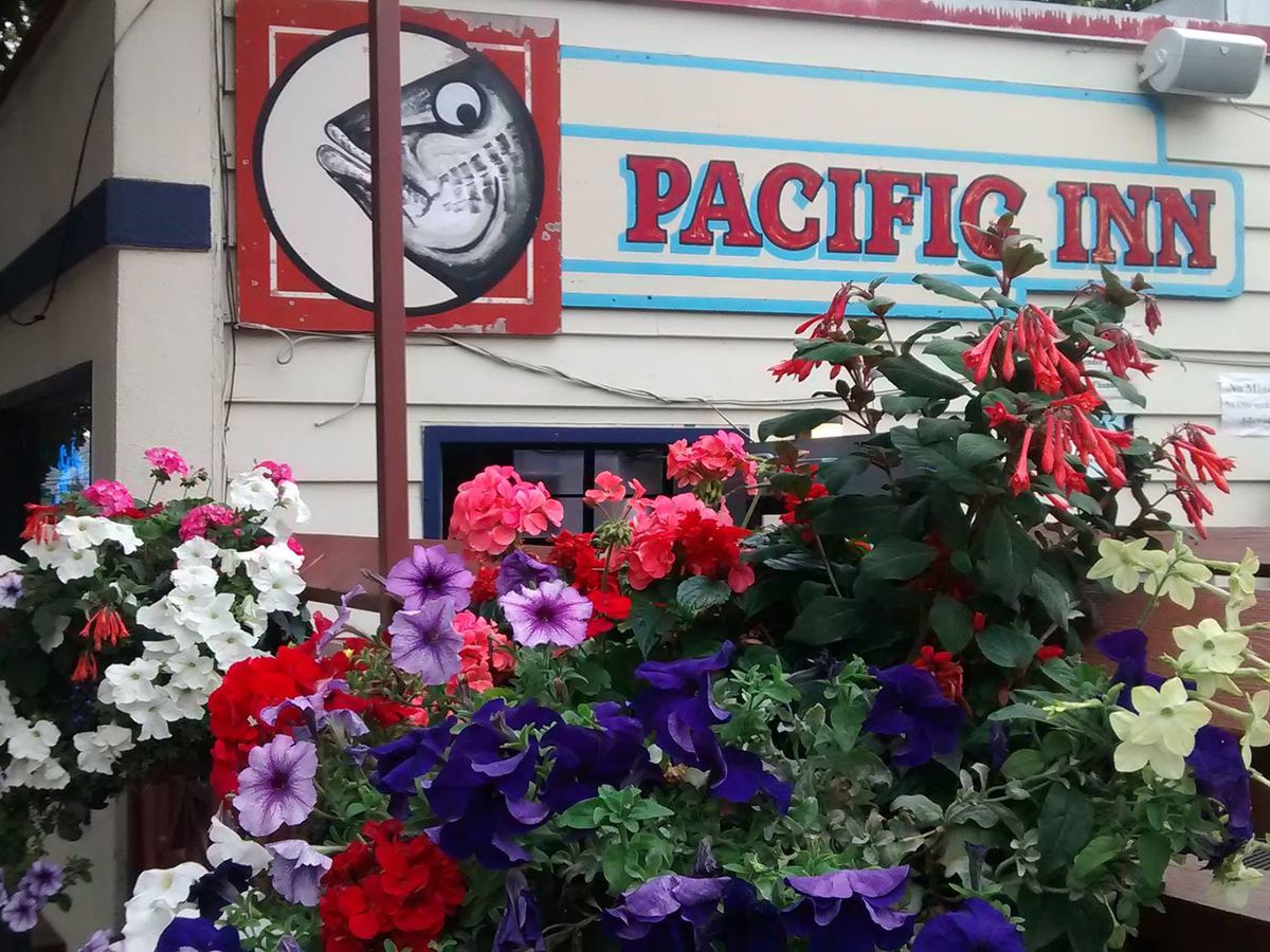 The exterior of Pacific Inn Pub, with the restaurant’s name and logo of a fish.