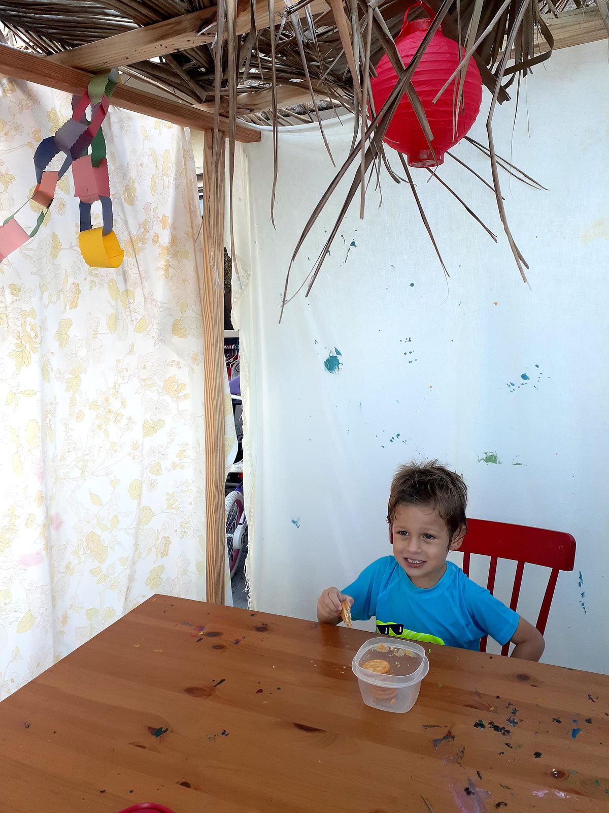 Mya Jaradat's son has a snack at a sukkah, a temporary structure built by Jews to commemorate Shukkot, at the family's home in Florida on Thursday, September 30, 2021.