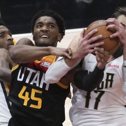 New Orleans Pelicans forward Herbert Jones (5), Utah Jazz guard Donovan Mitchell (45), and New Orleans Pelicans center Jonas Valanciunas (17) fight for the rebound during an NBA game at the Vivint Arena in Salt Lake City on Friday, Nov. 26, 2021. The Jazz lost 97-98.