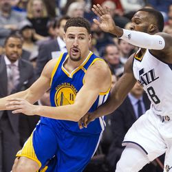 Golden State guard Klay Thompson (11) drives against Utah guard Shelvin Mack (8) during the second half of an NBA basketball game in Salt Lake City on Thursday, Dec. 8, 2016. Golden State defeated Utah with a final score of 106-99.