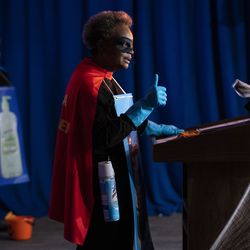 Dr. Allison Arwady, commissioner of the Chicago Department of Public Health, listens as Mayor Lori Lightfoot discusses Halloween in Chicago during a press conference at City Hall, Thursday afternoon, Oct. 1, 2020. Lightfoot and Arwady wore “Rona Destroyer” costumes and passed out candy to celebrate the announcement.