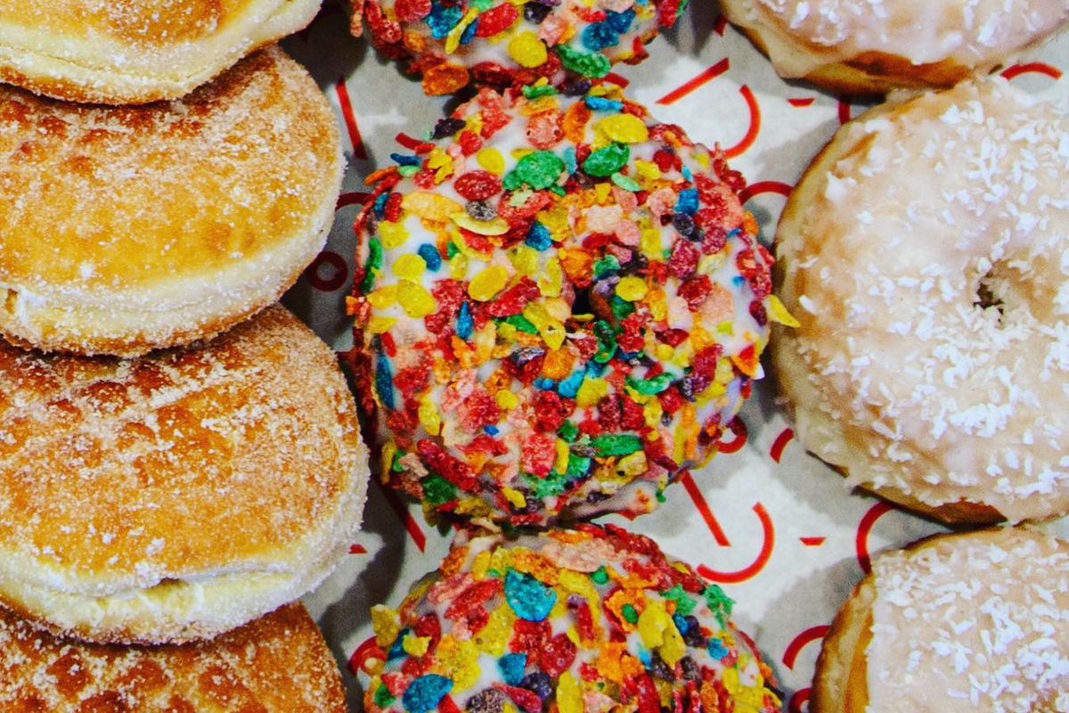 Three rows of jelly-filled, Fruity Pebbles, and frosted doughnuts from Hero Doughnuts