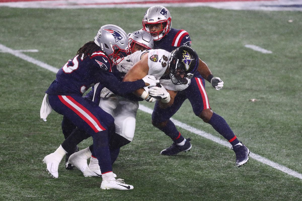 Mark Andrews #89 of the Baltimore Ravens is tackled by the New England Patriots during the first half at Gillette Stadium on November 15, 2020 in Foxborough, Massachusetts.