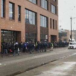 9:48 a.m. Cubs gameday employees line up on Waveland outside the office building