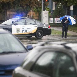 Police investigate a shooting just west of the intersection of 600 South and 900 East in Salt Lake City, Sunday, Sept. 28, 2014. 