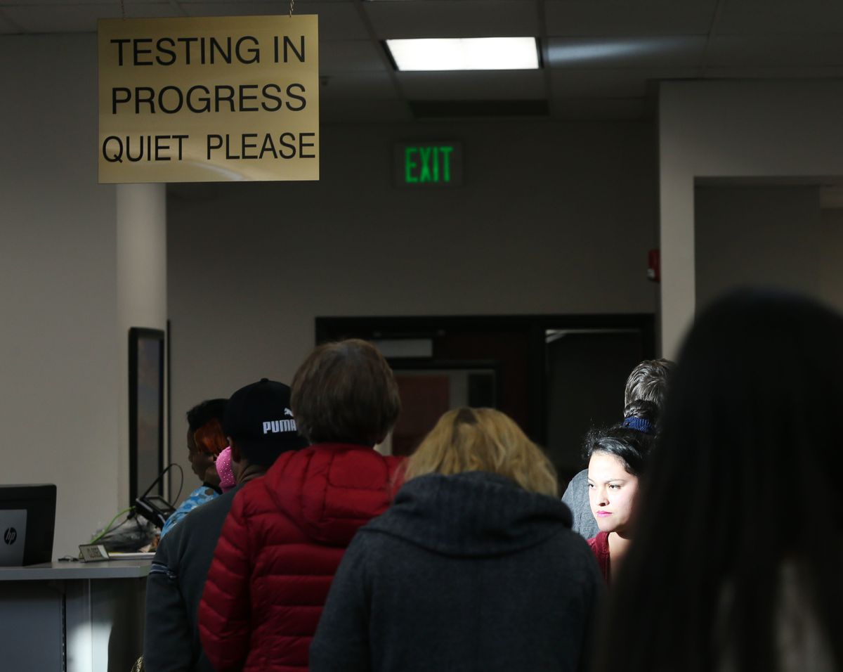 People wait at the Driver License Division in West Valley on Wednesday, Jan. 30, 2019.