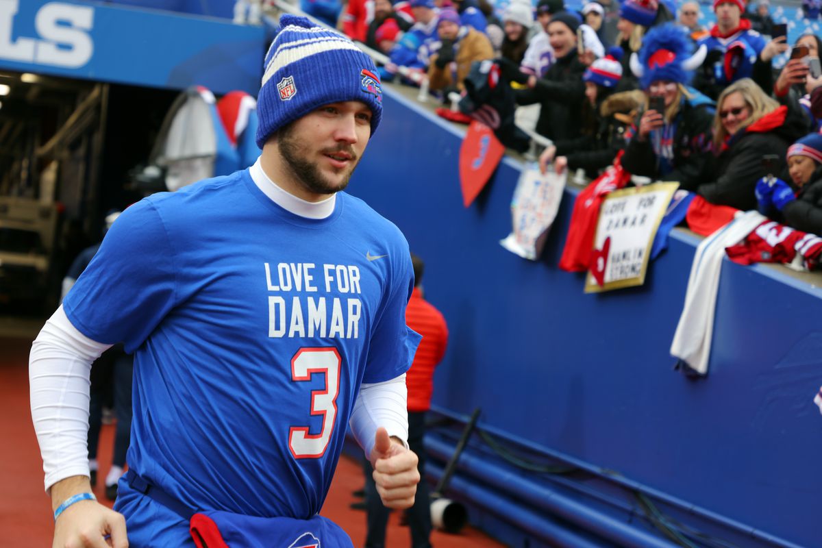 Quarterback Josh Allen #17 of the Buffalo Bills jogs onto the field wearing a Damar Hamlin shirt prior to the game against the New England Patriots at Highmark Stadium on January 08, 2023 in Orchard Park, New York.