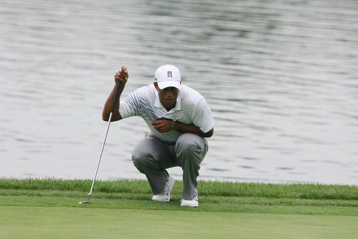 Sep 7, 2012; Carmel, IN, USA; Tiger Woods lines up his putt on the 18th green during the second round of the BMW Championship at Crooked Stick Golf Club. Mandatory Credit: Brian Spurlock-US PRESSWIRE