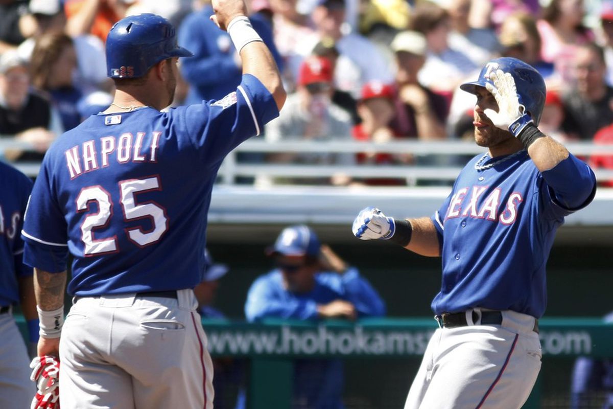 March 20, 2012; Mesa, AZ, USA; Texas Rangers catcher Dusty Brown (2) celebrates with Mike Napoli (25) after hitting a second inning homerun against the Chicago Cubs at HoHoKam Park.  Mandatory Credit: Rick Scuteri-US PRESSWIRE