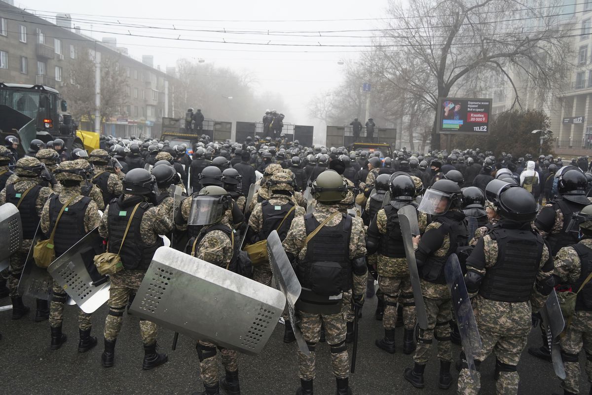 Riot police block a street to prevent demonstrators during a protest in Almaty, Kazakhstan, Wednesday, Jan. 5, 2022. Demonstrators denouncing the doubling of prices for liquefied gas have clashed with police in Kazakhstan’s largest city and held protests in about a dozen other cities in the country. 