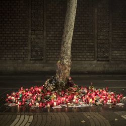 A memorial tribute of flowers, messages and candles to the van attack victims is seen on the historic Las Ramblas promenade, in Barcelona, Spain, Sunday Aug. 20, 2017. Authorities in Spain and France pressed the search Saturday for the supposed ringleader of an Islamic extremist cell that carried out vehicle attacks in Barcelona and a seaside resort, as the investigation focused on links among the Moroccan members and the house where they plotted the carnage.