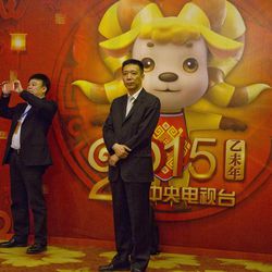 Men stand in front of a board with a 2015 Year of the Sheep mascot at a press conference for the China Central Television's annual hours-long Spring Festival Gala to be held in Beijing, Monday, Feb. 2, 2015. China’s state broadcaster is attempting to extend the international reach of its annual Chinese New Year variety show by making rights available to foreign broadcasters and putting related content on Twitter and other social network sites. 