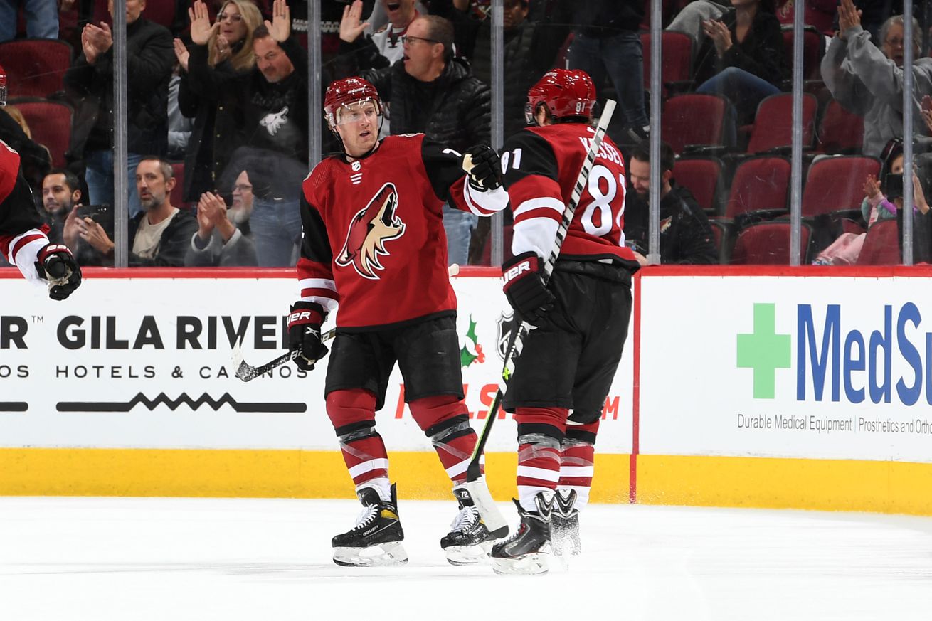 Phil Kessel #81 of the Arizona Coyotes celebrates with Travis Boyd #72 after scoring a goal against the Florida Panthers during the first period at Gila River Arena on December 10, 2021 in Glendale, Arizona.