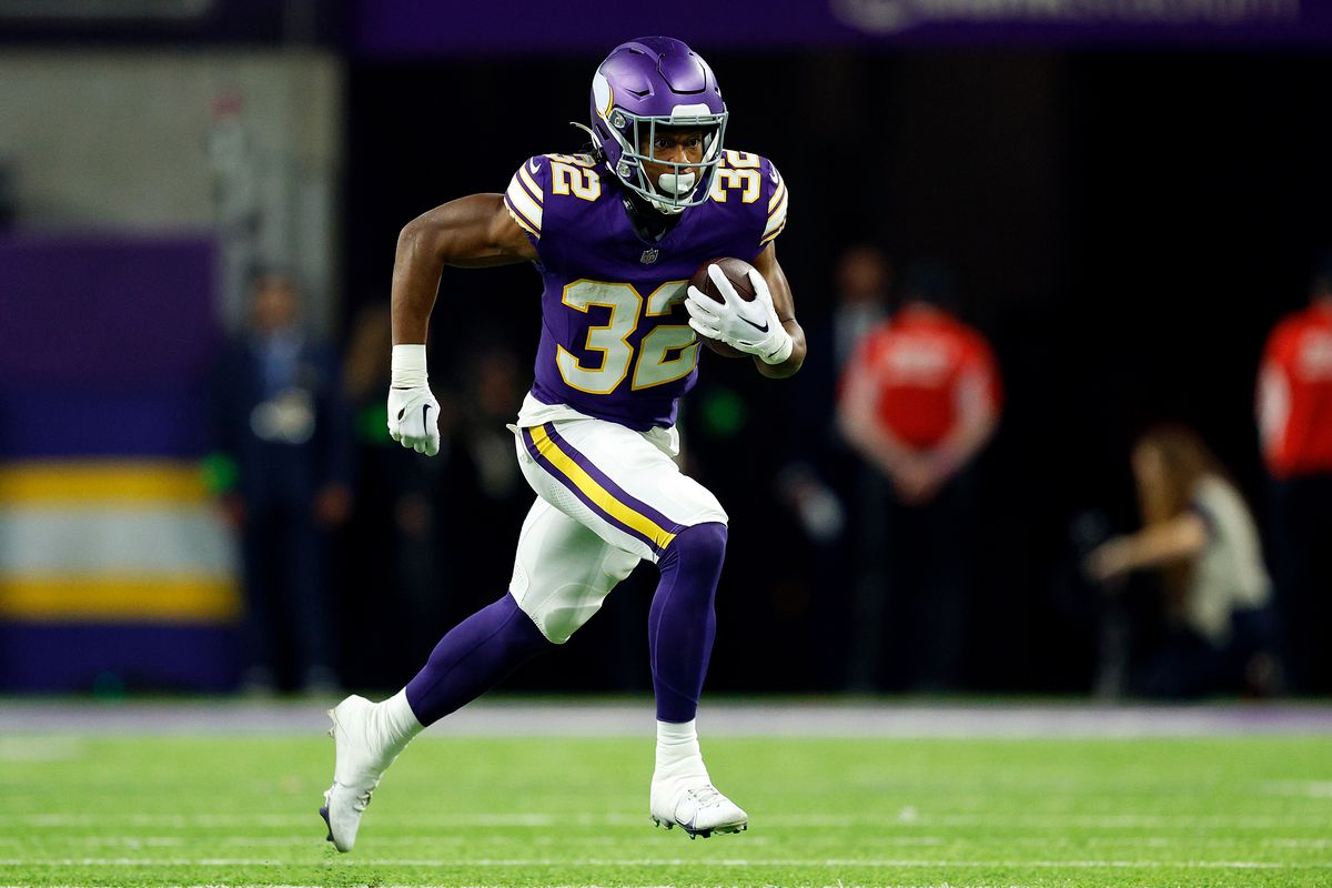 Ty Chandler #32 of the Minnesota Vikings runs with the ball against the Chicago Bears in the second half at U.S. Bank Stadium on November 27, 2023 in Minneapolis, Minnesota. The Bears defeated the Vikings 12-10.