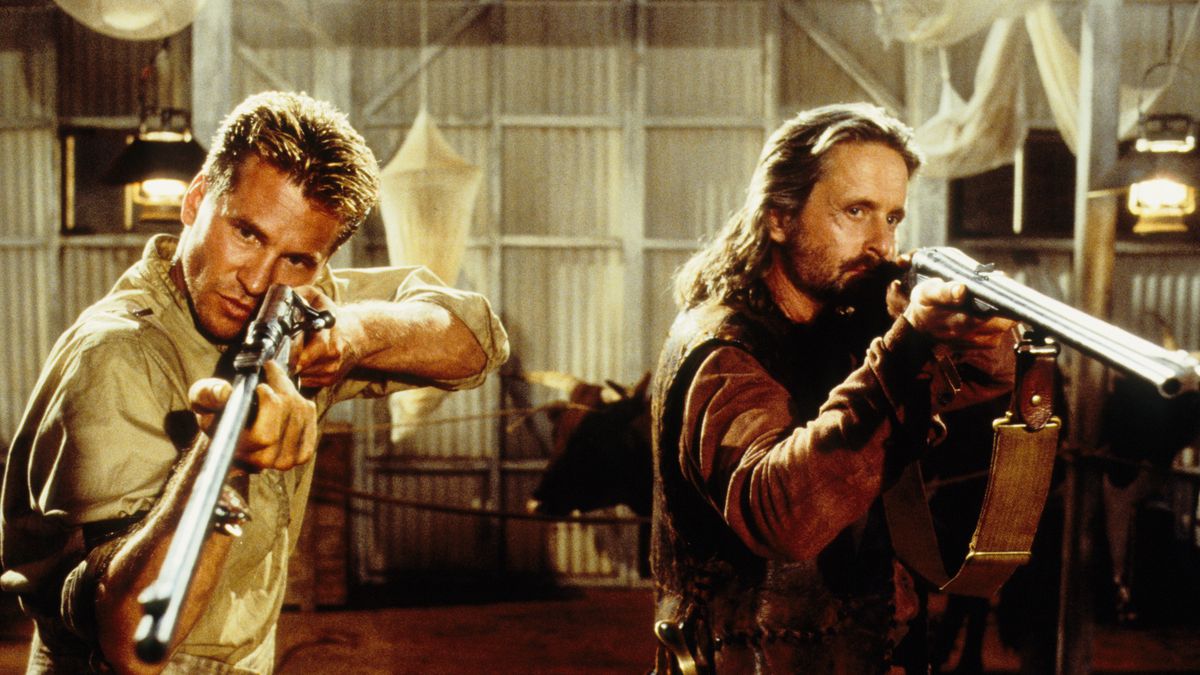 Val Kilmer and Michael Douglas aim shotguns offscreen in The Ghost and the Darkness