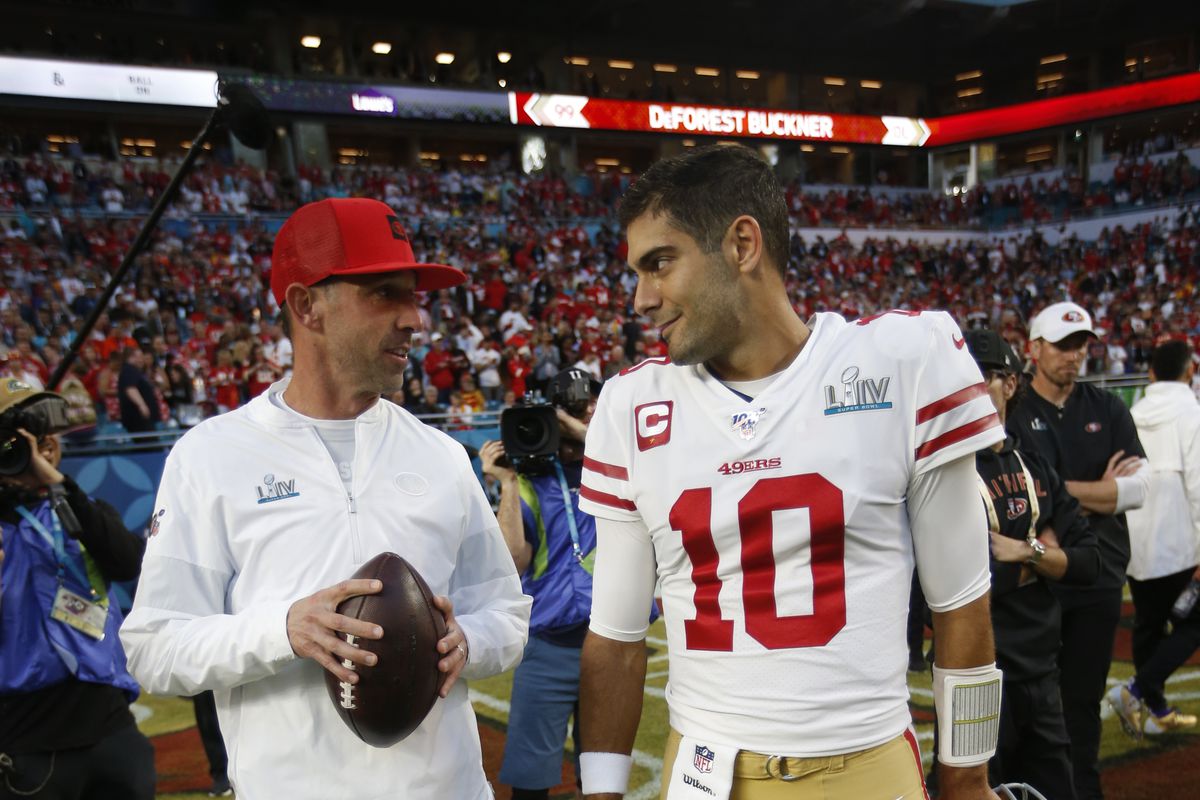Head Coach Kyle Shanahan and Jimmy Garoppolo #10 of the San Francisco 49ers talk on the field before the game against the Kansas City Chiefs in Super Bowl LIV at Hard Rock Stadium on February 2, 2020 in Miami, Florida.