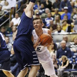 Brigham Young Cougars guard Kyle Collinsworth (5) drives on San Diego Toreros forward/center Brandon Perry (2) in Provo Thursday, Feb. 19, 2015. 