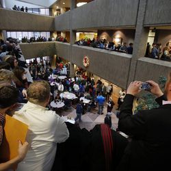 Couples wait to get marriage licenses outside the Salt Lake County clerk's office, Monday, Dec. 23, 2013. At left are Addison Rose and Todd Markham. At right is Bobby Smith. U.S. District Judge Robert Shelby denied a motion by the state of Utah to halt same-sex marriages pending an appeal.
