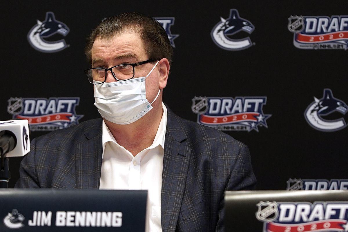General manager Jim Benning of the Vancouver Canucks sits at the draft table during the rounds 2-7 of the 2020 NHL Entry Draft at Bell MTS Place on October 07, 2020 in Vancouver, British Columbia, Canada. The 2020 NHL Draft was held virtually due to the ongoing Coronavirus pandemic.