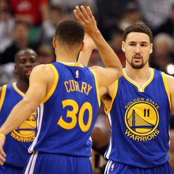 Golden State Warriors guard Klay Thompson (11) high fives guard Stephen Curry (30) in the first half of an NBA regular season game against the Utah Jazz at the Vivint Arena in Salt Lake City, Wednesday, March 30, 2016.