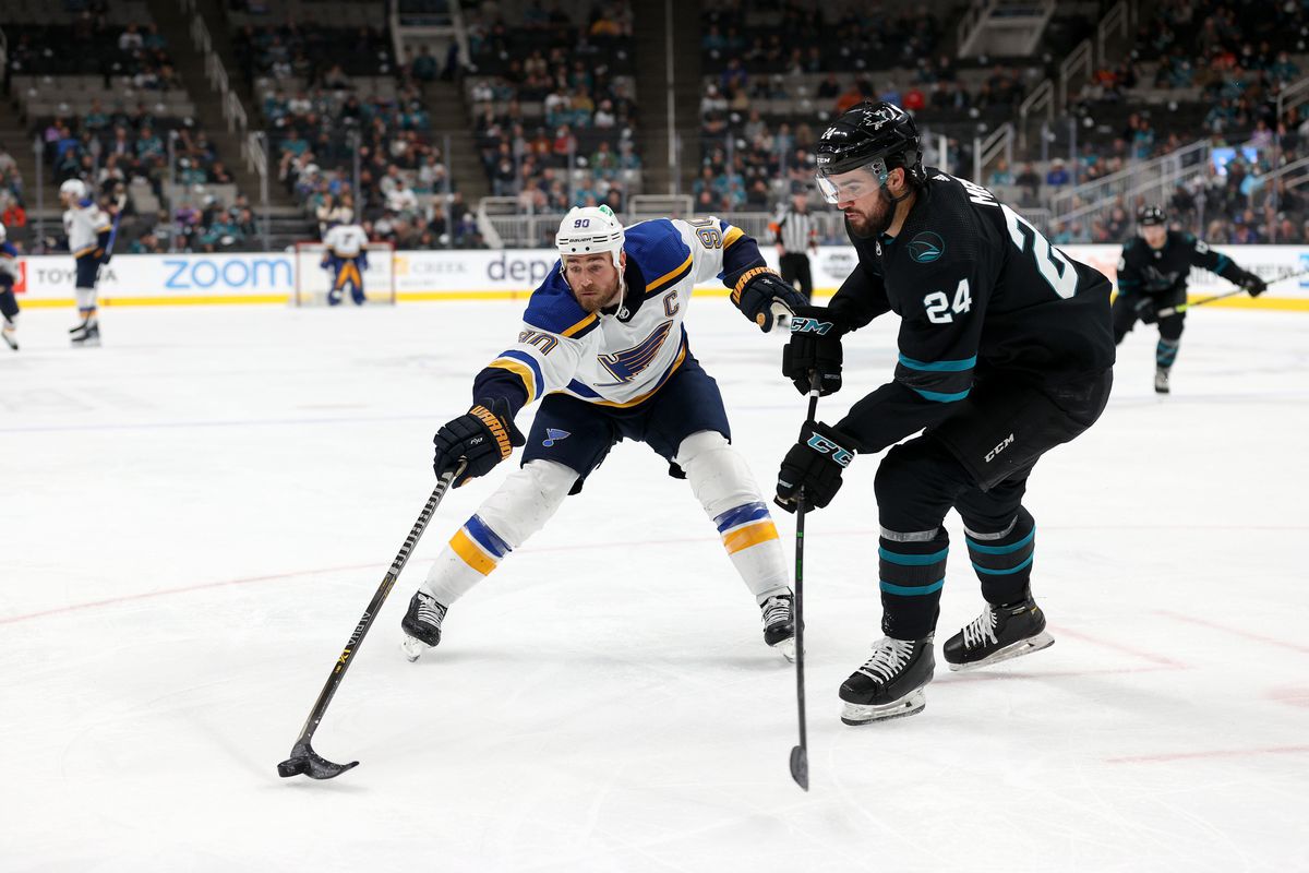 Ryan O’Reilly #90 of the St. Louis Blues and Jaycob Megna #24 of the San Jose Sharks go for the puck at SAP Center on April 21, 2022 in San Jose, California.