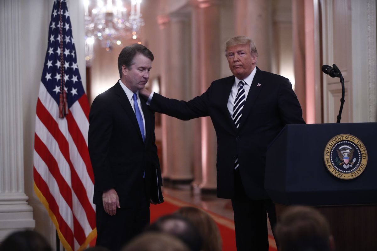 Trump with his hand on Kavanaugh’s shoulder at a press conference at the White House. 