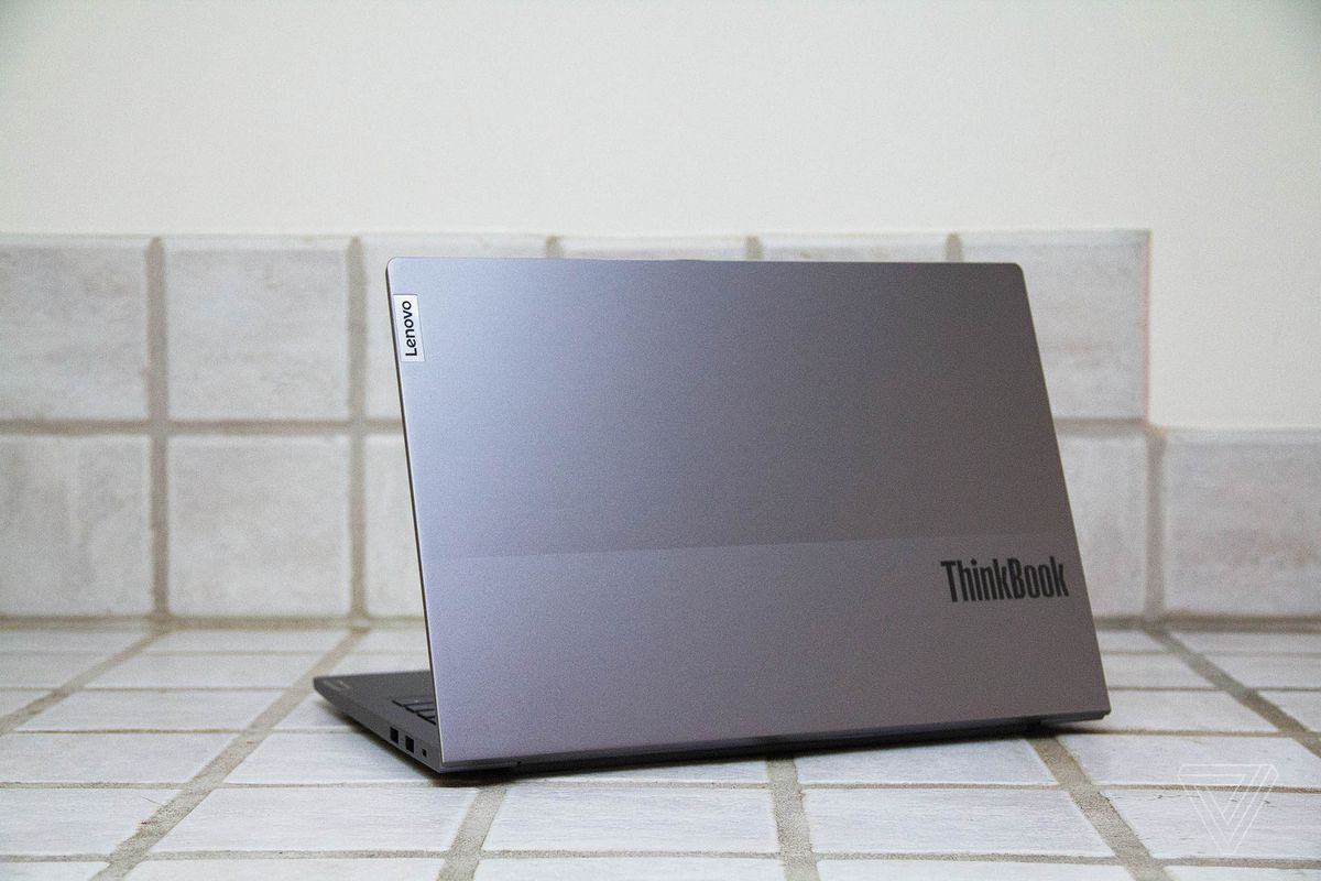 The Lenovo ThinkBook 13s on a white-tile countertop seen from the back, angled to the left.