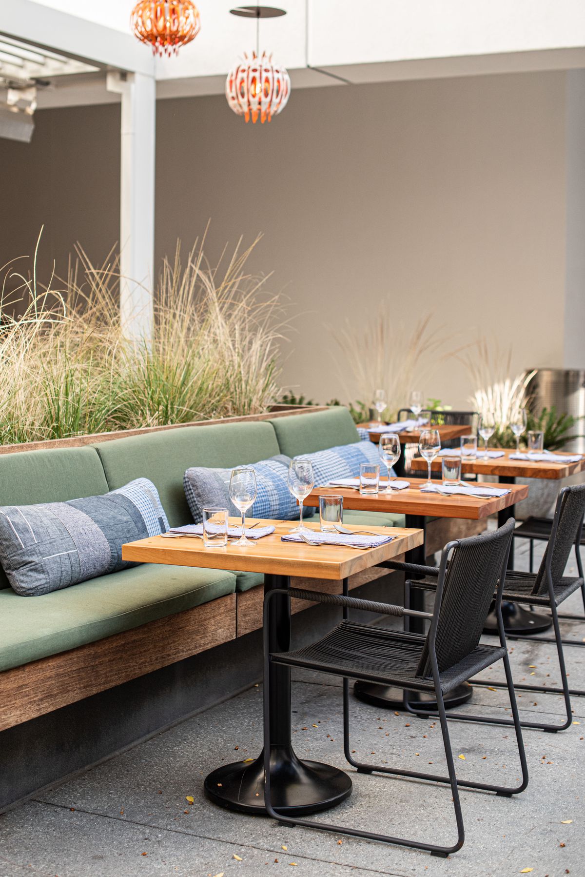 A vertical look at olive green seating for a new indoor-outdoor restaurant.