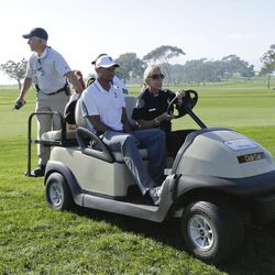 Tiger Woods is driven off the course in a cart after withdrawing during the first round of the Farmers Insurance Open golf tournament Thursday, Feb. 5, 2015, in San Diego. 