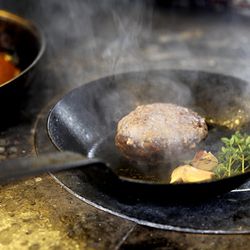 Frying the burger with garlic and herbs