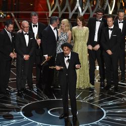 Alejandro G. Inarritu, center, and the cast and crew of “Birdman or (The Unexpected Virtue of Ignorance)” accept the award for the best picture at the Oscars on Sunday, Feb. 22, 2015, at the Dolby Theatre in Los Angeles. 