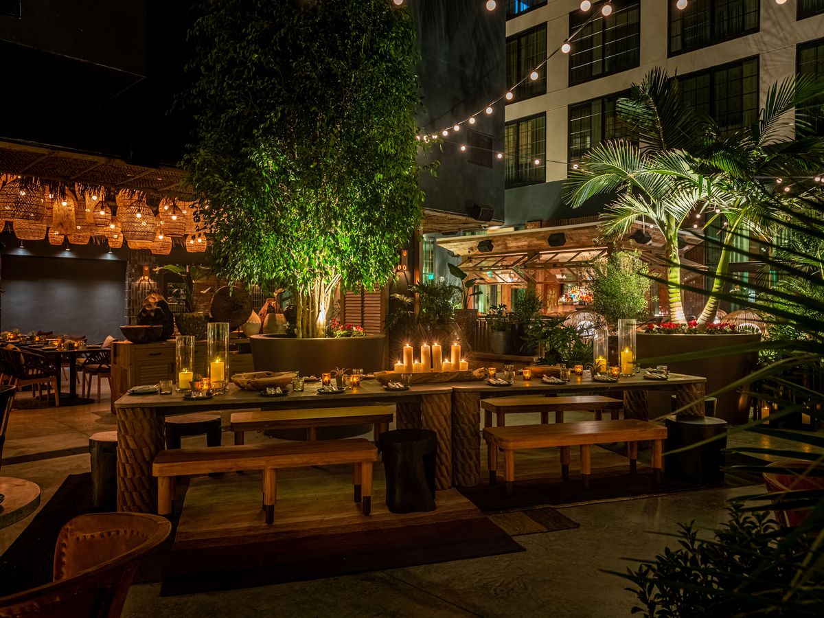 A dark outdoor dining room with string lights at a new LA restaurant.