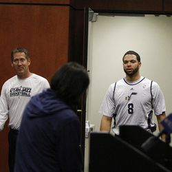Jeff Hornacek, left, and Deron Williams enter practice in Salt Lake City Friday, a day after Jerry Sloan resigned as head coach of the team.