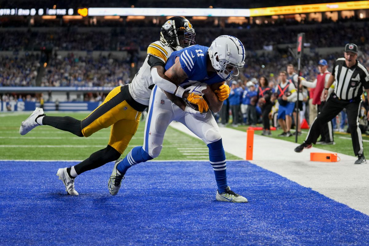 Pittsburgh Steelers cornerback James Pierre (42) tries to bring Indianapolis Colts wide receiver Michael Pittman Jr. (11) down as he scores a touchdown Monday, Nov. 28, 2022, during a game against the Pittsburgh Steelers at Lucas Oil Stadium in Indianapolis.