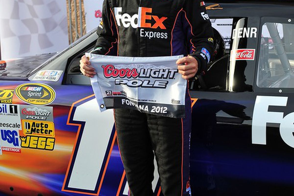 March 23, 2012; Fontana, CA, USA; Sprint Cup Series driver Denny Hamlin (11) wins pole position after qualifying for the Auto Club 400 at Auto Club Speedway. Mandatory Credit: Gary A. Vasquez-US PRESSWIRE