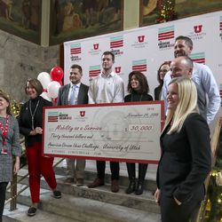 University of Utah President Ruth V. Watkins and Lt. Gov. Spencer Cox present members of Mobility as a Service with a check for being one of three finalists in the American Dream Ideas Challenge during ceremony at the University of Utah in Salt Lake City on Thursday, Nov. 29, 2018.