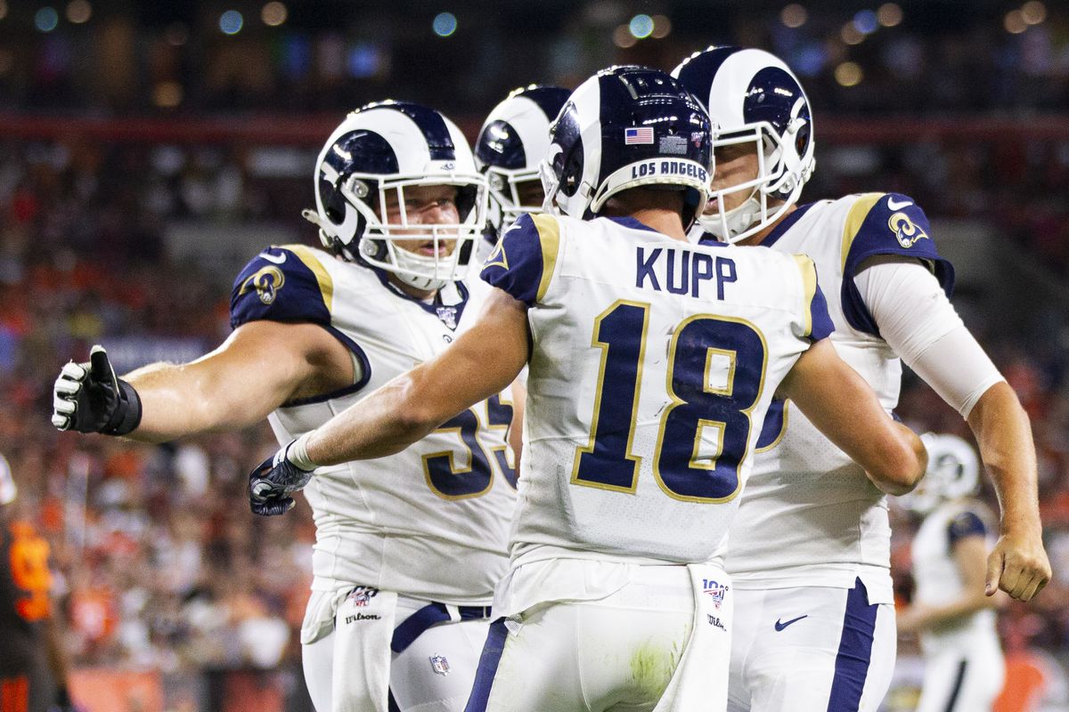Los Angeles Rams wide receiver Cooper Kupp celebrates his touchdown with center Brian Allen and quarterback Jared Goff during the third quarter at FirstEnergy Stadium.