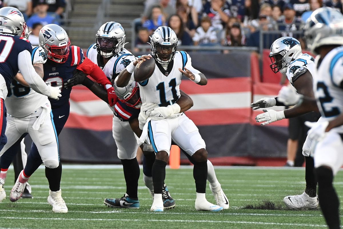 Carolina Panthers quarterback PJ Walker (11) gets sacked by New England Patriots linebacker Josh Uche (55) during the first half of a preseason game at Gillette Stadium