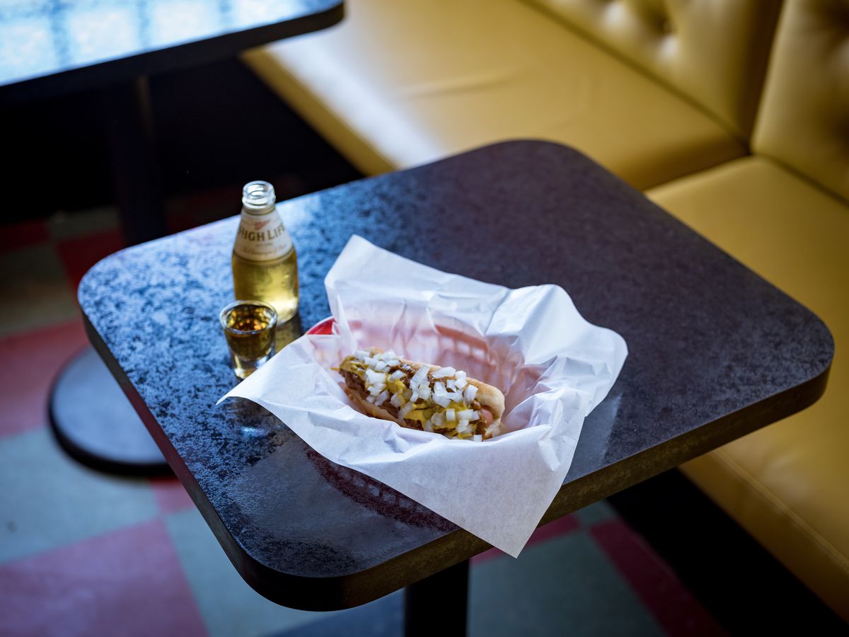 Delray’s coney dog with Nickel’s Miller High Life pony and&nbsp;a shot