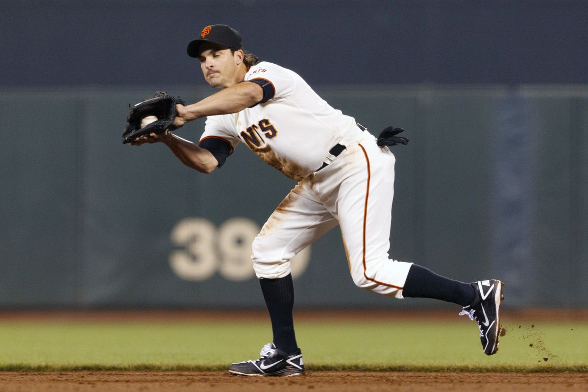 SAN FRANCISCO, CA - JULY 23: Ryan Theriot #5 of the San Francisco Giants forgets to remove his glove and a practice ball while stealing second base in the fifth inning. (Photo by Jason O. Watson/Getty Images)