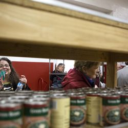 Attendees on the Interfaith bus tour make their way through the food bank section of The Salvation Army Wednesday, Feb. 24, 2016 in Salt Lake City. The tour, sponsored by the Salt Lake Interfaith Roundtable, allows patrons from all religious backgrounds to experience and educate themselves on other walks of faith.  