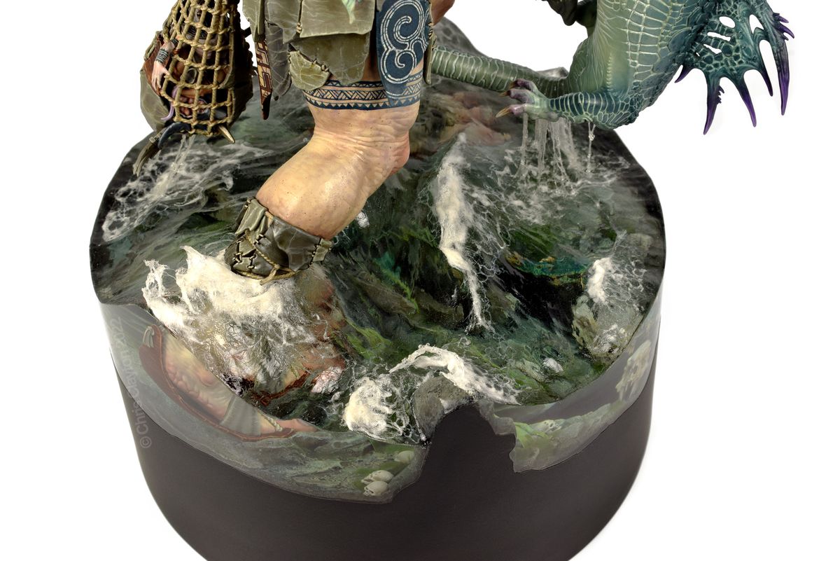 An extreme close-up of the water - resin poured on the base - of two large figures in a diorama fighting.  Waves are carefully sculpted, and the water is clear, yet frothy at the top.