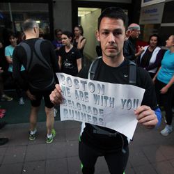 A runner shows a banner reading: "Boston we are with you - Belgrade runners" in an organized memorial run to show solidarity with victims of the Boston Marathon bombing, Tuesday, April 16, 2013, in Belgrade, Serbia. The explosions Monday afternoon killed at least three people and injured more than 140. 