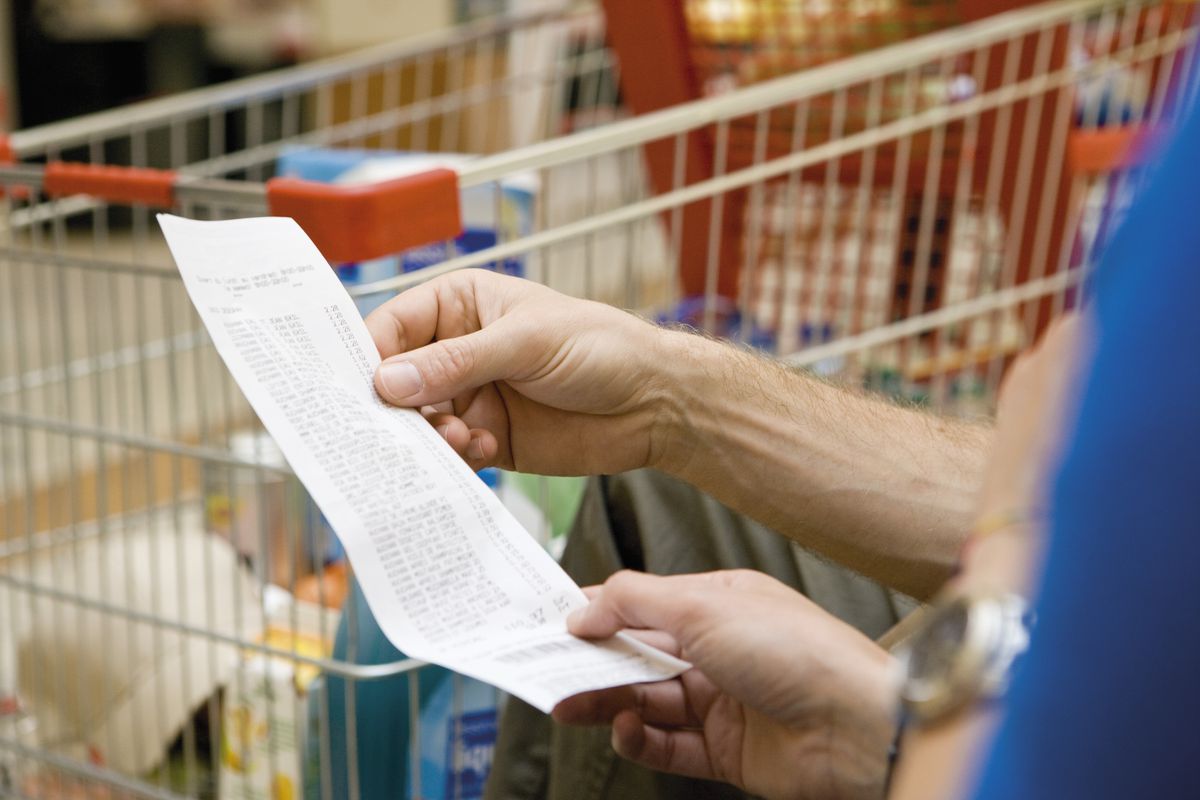 A customer holds a sales receipt.