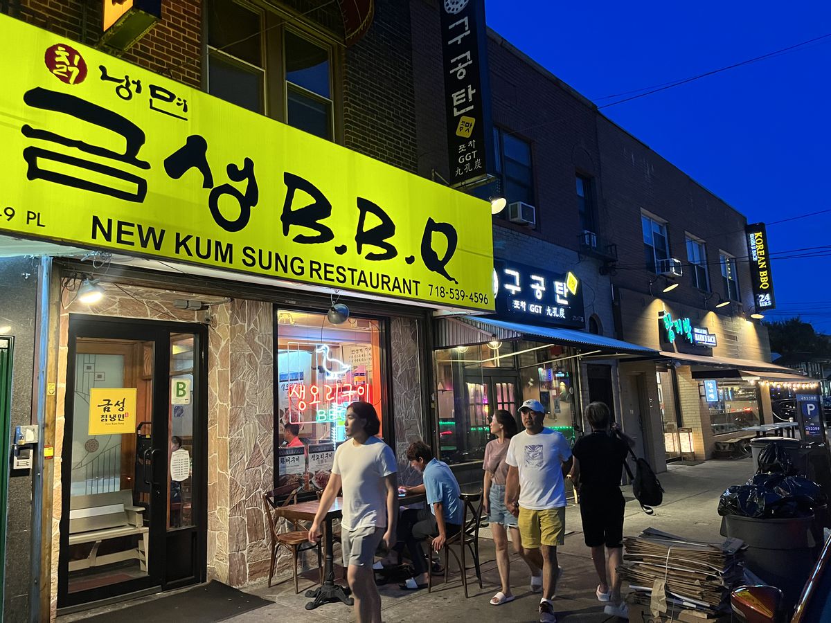 The exterior of a neighborhood Korean restaurant with a yellow sign. 
