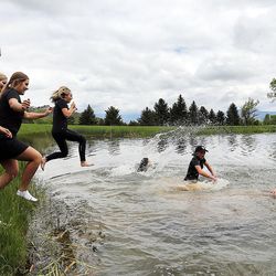 Lone Peak golfers celebrate winning the girls 5A state championship at Wasatch Mountain State Park in Midway on Tuesday, May 17, 2016, by jumping in the lake.