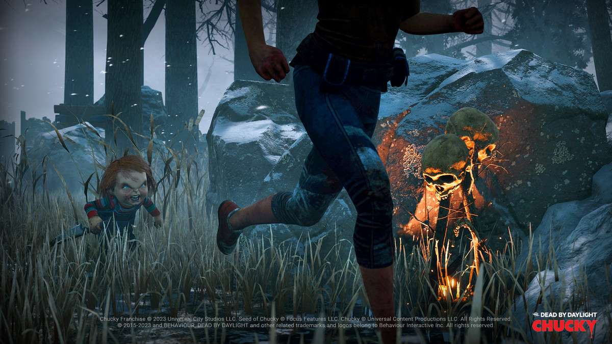 Chucky chases a survivor through knee-high grass in a screenshot from Dead by Daylight